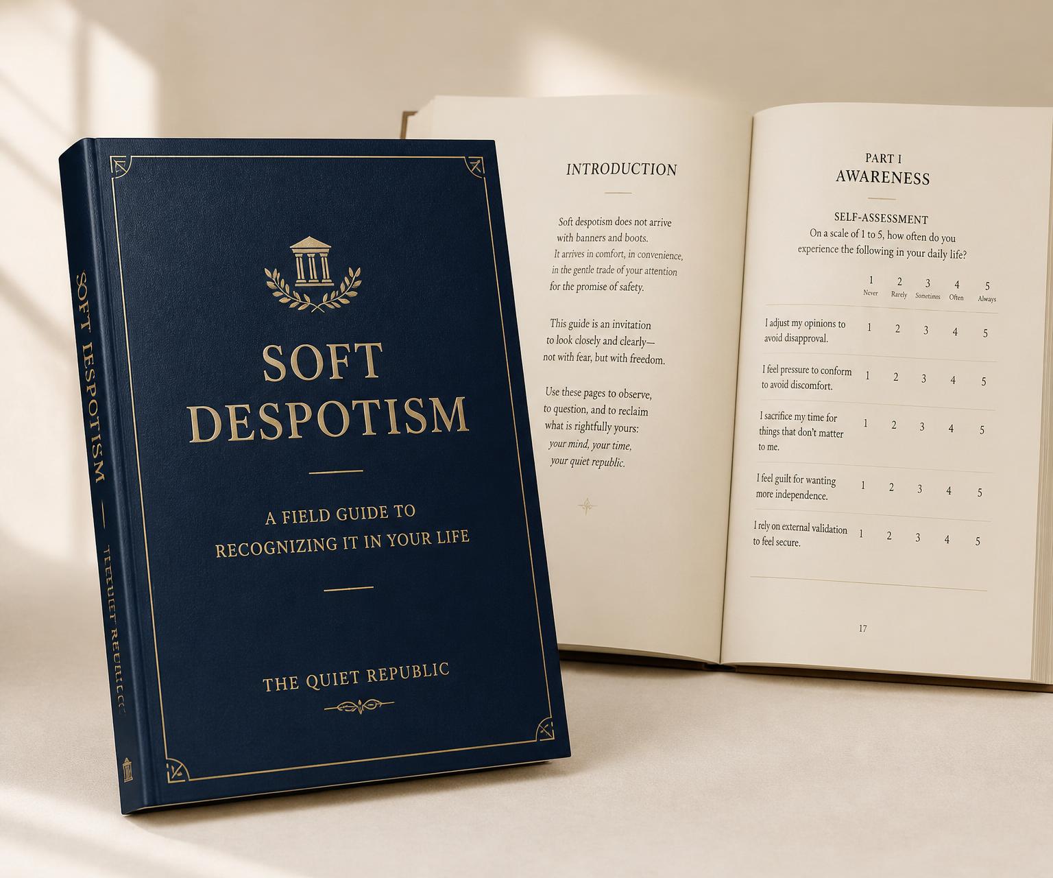 Soft Despotism field guide — deep navy cover with brass foil, shown beside an open workbook spread